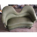 A late Victorian upholstered boudoir spoonback sofa