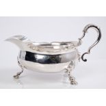 Unusual Georgian silver sauce boat with scroll handle and engraved armorial,