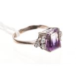 Amethyst and diamond dress ring with a square step cut amethyst flanked by six brilliant cut