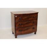 Early Victorian mahogany bow front chest, having three graduated drawers on turned feet,
