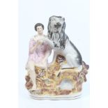 Victorian Staffordshire figure of Daniel holding the paw of a lion, on rocky base,