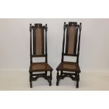 Pair of 17th century Carolean carved hall chairs, each with high carved back,