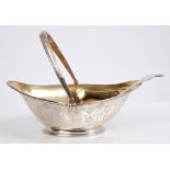 Victorian silver sugar basket of boat-shaped form, with engraved floral decoration,