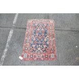 Good early Persian rug with allover flower head and branchwork motifs on navy blue ground within