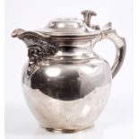 George V Scottish silver hot water jug of bellied form, with face mask spout,