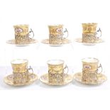 Set of six Edwardian silver coffee cup holders with pierced floral decoration and scroll handles