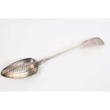 William IV Irish silver fiddle pattern straining spoon with fixed grille and engraved armorial