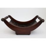 Regency mahogany cheese coaster of typical crescent form with turned carrying handles on squat bun