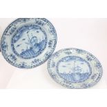 Pair early 19th century Delft blue and white tin glazed pottery chargers painted with trading