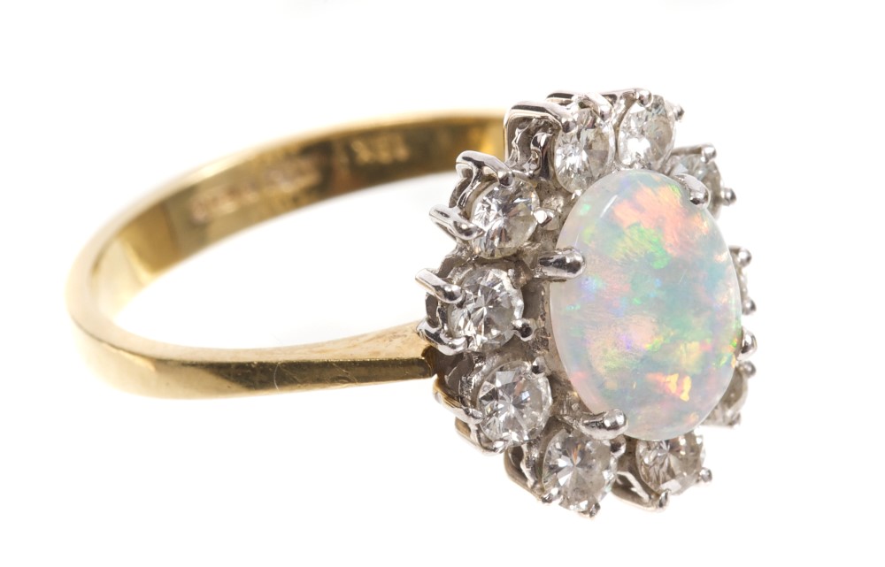 Opal and diamond cluster ring, the oval opal cabochon measuring 8.80mm x 6.85mm x 1.