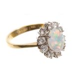 Opal and diamond cluster ring, the oval opal cabochon measuring 8.80mm x 6.85mm x 1.