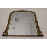 Victorian gilt gesso overmantel mirror with original shallow arched plate within ribbon and boss
