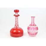 Victorian cranberry overlaid glass decanter and stopper with slice cut decoration and star cut foot,