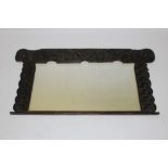 Early 20th century Arts and Crafts carved oak overmantel mirror,