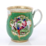 18th century Worcester baluster-shaped mug with polychrome exotic bird reserves on pale green and