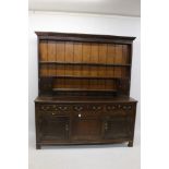 George III oak high dresser, the boarded rack with two enclosed cupboards,
