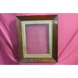 Victorian rosewood frame with decorated gilt slip,