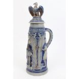 Late 19th century German salt glazed stoneware tankard with cover with eagle surmount and moulded
