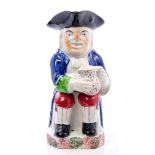 19th century Toby jug of typical form, with blue, green,