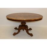 Victorian inlaid walnut oval loo table with finely figured and floral scroll inlaid top on carved