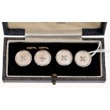 Set of four mother of pearl dress studs in white and yellow metal mounts, stamped '9ct',