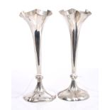 Pair Edwardian silver spill vases of trumpet form, with flared necks, on petal pedestal bases,
