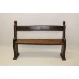 Rare early English oak pew with bar back and solid seat between ends with shaped finials,
