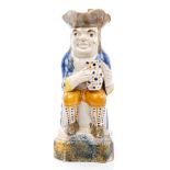 Late 18th century Pratt-type Toby jug with seated figure wearing a tricorn hat,