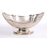 George V silver dish of boat-shaped form, with fluted panels and pierced border,