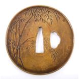 19th century Edo period Japanese bronze and gilt heightened tsuba, circular dished form,