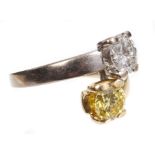 A yellow and 'white' diamond two stone crossover ring,