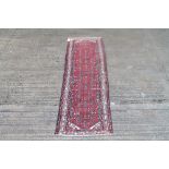 Hamadan runner with strapwork ornament on red ground in multiple borders,