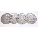 Set of four American coasters of circular form, with overlaid white metal floral decoration,