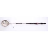 George IV silver toddy ladle of circular form, with embossed floral decoration,