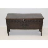 Antique oak and elm six-plank coffer with hinged lid and round carved front raised on V-cut ends,