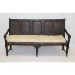 Mid-18th century oak settle with five fielded panel back and downswept arms,