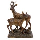 Late 19th century Austrian cold painted bronze group of a stag and doe, on naturalistic base,
