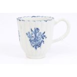 18th century Lowestoft blue and white fluted coffee cup with printed floral sprays and loop handle,