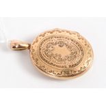 Victorian engraved yellow metal oval locket with foliate engraved decoration,