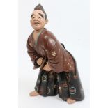 Late 19th century Japanese polychrome painted terracotta figure of a musician in traditional