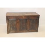 Early 18th century oak coffer with hinged plank top and triple panel front,