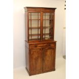 Regency mahogany bookcase with moulded cornice, enclosed above by pair of astragal glazed doors,