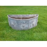 Good quality old lead demi-lune garden planter with cast sunburst face decoration,