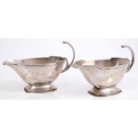 Pair 1930s silver sauce boats of faceted form, in the Art Deco style, with open scroll handles,