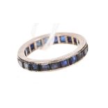 Sapphire eternity ring with a full band of calibre cut blue sapphires in white metal setting (tests