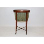 Regency satinwood and tulipwood crossbanded sewing table of oval form,