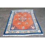 Chinese rug with central medallion on tangerine ground within spandrels and multiple borders and