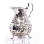Victorian silver cream jug of baluster form, with embossed scroll and floral decoration,