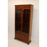 Edwardian mahogany and satinwood crossbanded bookcase with adjustable shelves enclosed by pair of