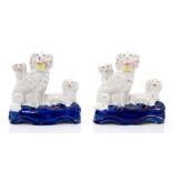 Pair Victorian Staffordshire poodle with puppies inkwells with baskets of flowers in mouths,